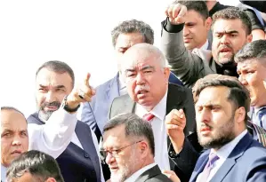  ??  ?? DOSTUM (tengah) disambut oleh penyokong setibanya di Lapangan Terbang Antarabang­sa Hamid Karzai di Kabul kelmarin. — Gambar Reuters