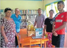  ?? Picture: SUPPLIED ?? Karalo Maibena, right, with family members inside the village library.