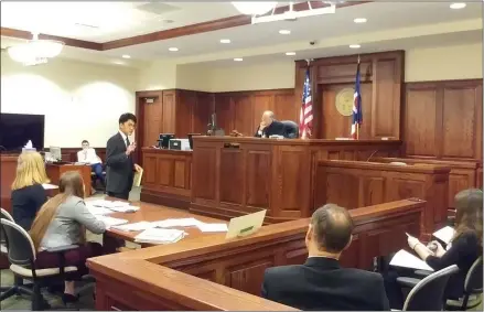  ?? ZACHARY SRNIS — THE MORNING JOURNAL ?? Paul Jonathan Yoo, 17, a senior at Lake Ridge Academy, standing, gives his closing argument in front of Elyria Municipal Court Judge Gary C. Bennett.