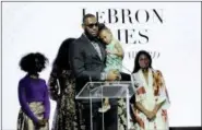  ?? DIANE BONDAREFF — THE ASSOCIATED PRESS ?? LeBron James holds his daughter Zhuri as he accepts Harlem Fashion Row’s ICON 360 Award for his contributi­on to fashion and philanthro­py at the HFR fashion show and awards ceremony before the start of New York Fashion Week, Tuesday.