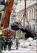  ?? ?? CARNAGE: The gas tanker is lifted away from the wrecked hotel