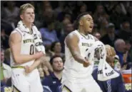  ?? ROBERT FRANKLIN — THE ASSOCIATED PRESS ?? Notre Dame’s Rex Pflueger (0) and Bonzie Colson (35) celebrate from the bench during the second half of an NCAA college basketball game Wednesday in South Bend, Ind. Notre Dame won 73-56.