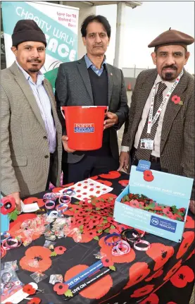  ??  ?? PROUD TO HELP: Naveed Uz Zafar, right, with fellow Muslim poppy sellers