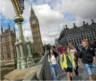  ??  ?? Tourists make their way over Westminste­r Bridge in London, England.