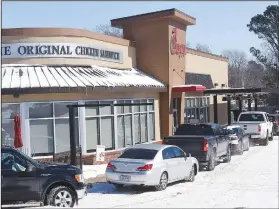  ??  ?? Customers line up Feb. 16 to patronize the drive-through at Chick-fil-A in Bentonvill­e. (NWA Democrat-Gazette/Flip Putthoff)