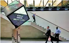  ??  ?? People walk through the lobby of the London Stock Exchange in London