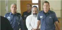  ?? (Flash90) ?? GUIDED-IMAGERY THERAPIST Alon Shamir arrives at Jerusalem District Court yesterday, where he was indicted for raping three sisters who were former patients.