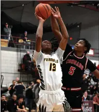  ?? JASON SCHMITT — FOR MEDIANEWS GROUP ?? Ferndale senior Chris Williams scores two of his nine points as Warren Michigan Collegiate’s Dylan Grant defends Wednesday night during the Eagles’ 69-50win over the Cougars at Hazel Park High School.