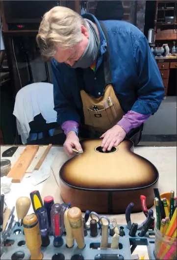  ?? (AP/The Huntsville Times/Matt Wake) ?? Luthier Danny Davis works on a guitar at Danny Davis Guitars in Huntsville, Ala.