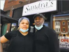  ?? Brian A. Pounds / Hearst Connecticu­t Media ?? Owners Sandra and Miguel Pittman outside their popular Sandra’s Next Generation restaurant in New Haven on Sunday. They said aspects of their business, like catering, have been adversely affected by the coronaviru­s pandemic.