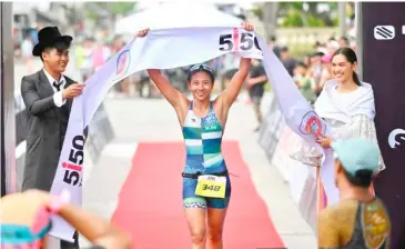  ?? PHOTOGRAPH COURTESY OF IRONMAN ?? SOUTHEAST Asian Games gold medalist Kim Mangrobang tightens up race in the women’s division of 5150 Triathlon CamSur.