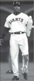  ??  ?? San Francisco Giants’ Barry Bonds carries the second base bag off the field after recording his 500th career stolen base against the Los Angeles Dodgers, becoming the first player ever with 500 stolen bases and 500 home runs, 14 years ago today.