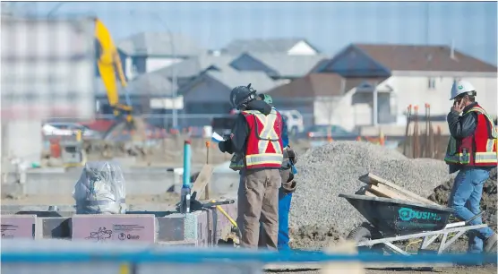  ?? CALGARY HERALD/ FILES ?? Constructi­on workers build a new school, Nelson Mandela High School, in northeast Calgary. When the school, located next to the Genesis Centre in Falconridg­e, opens in fall 2016, it will house 1,800 students in grades 10 and 11 before expanding to...