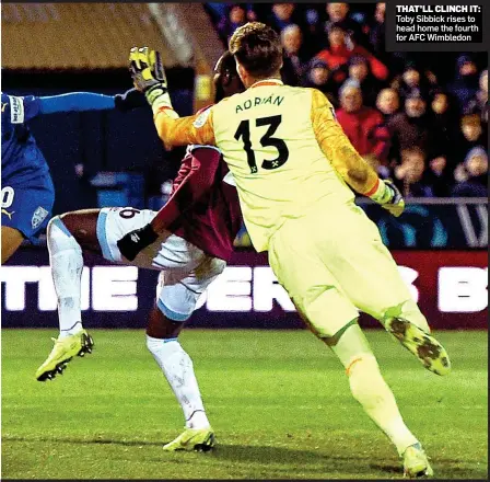  ??  ?? THAT’LL CLINCH IT: Toby Sibbick rises to head home the fourth for AFC Wimbledon