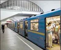  ?? AP/SERGEI CHUZAVKOV ?? Passengers board a subway train in Kiev, Ukraine, on June 28, a day after a cyberattac­k paralyzed many computer systems.