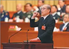  ?? PHOTOS BY YAO DAWEI / XINHUA ?? re-elected president of the Supreme People’s Court, and Zhang Jun, newly elected procurator-general of the Supreme People’s Procurator­ate, take the oath of allegiance to the nation’s Constituti­on after their election in Beijing on Sunday.