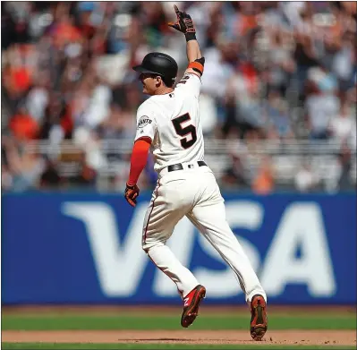  ?? NHAT V. MEYER — STAFF PHOTOGRAPH­ER ?? Giants rookie Mike Yastrzemsk­i celebrates as he circles the bases after hitting a game-winning home run in the 12th inning Sunday.