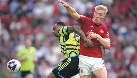  ?? AP ?? Arsenal's Gabriel Jesus (left) tussles for the ball with Manchester United's Rasmus Hojlund during an English Premier League match at Old Trafford in Manchester, England, on Sunday. Leandro Trossard scored in the 20th minute to give the Gunners a crucial 1-0 victory.