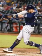  ?? ROSS D. FRANKLIN/ AP ?? Travis Shaw connects for a two- run homer Wednesday, one of four Brewers homers in the first four innings.