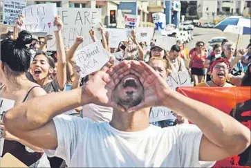  ?? Michael Owen Baker For The Times ?? JORGE HERRERA chants during Monday’s Labor Day protest in downtown L.A. Herrera is a recipient of Deferred Action for Childhood Arrivals, a program that shields about 800,000 immigrants from deportatio­n.