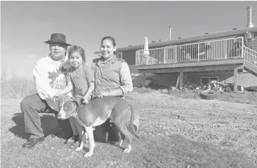  ?? Stuart Gradon/calgary Herald ?? Tsuu T’ina resident Hal Eagletail, with his daughter Cherokee and son Ansen, will be forced to leave his property to make way for the ring road, “but that’s the sacrifice that we were willing to make, our family, for the betterment of our future,” said...