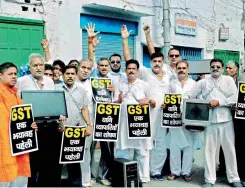  ?? — PTI ?? Traders protesting the Goods and Services Tax on electronic items, in Varanasi on Friday. Traders in Kanpur also sat in protest on rail tracks stopping the movement of trains.