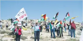  ??  ?? PEACE NOW protesters march outside Kochav Hashahar on Friday.