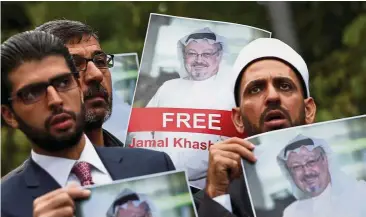  ??  ?? In solidarity: Human rights activists and friends of Saudi journalist Jamal Khashoggi hold his pictures during a protest outside the Saudi Consulate in Istanbul, Turkey recently.