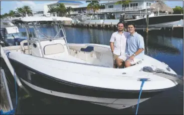  ??  ?? Freddy (right) and Joel poses on their boat.