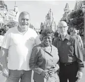  ?? JOHN RAOUX/AP ?? Walt Disney World employees from left, Chuck Milam, Earliene Anderson and Forrest Bahruth gather Aug. 30 at the Magic Kingdom in Lake Buena Vista, Fla.