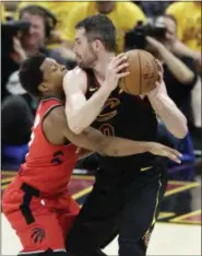  ?? TONY DEJAK — THE ASSOCIATED PRESS ?? The Raptors’ Kyle Lowry defends the Cavaliers’ Kevin Love in the second half on May 7 at Quicken Loans Arena.