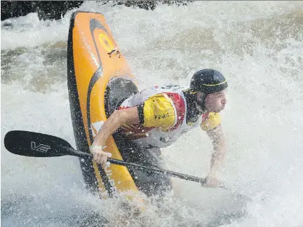  ?? ASHLEY FRASER/OTTAWA CITIZEN ?? Kayaker Gavin Barker of the United Kingdom had that sinking feeling as he battled the Ottawa River near Beachburg. Barker was competing Wednesday at the 2015 ICF Freestyle Kayak World Championsh­ips. The event has attracted 211 paddlers from 29 countries.