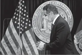  ?? BRENDAN MCDERMID/POOL PHOTO VIA AP ?? New York Gov. Andrew Cuomo exits following a news conference at his offices Wednesday in New York.