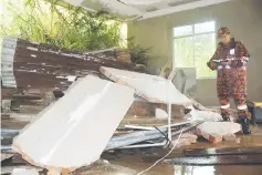  ??  ?? The eroded soil crashed into the wall of Kaya’s house, destroying his bedroom.