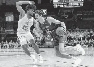  ?? D.A. VARELA dvarela@miamiheral­d.com ?? Norchad Omier defends Boston College’s 7-footer, Quinten Post, during their game March 6. Miami lost twice to BC this season and faces the Eagles in the ACC tournament opener Tuesday night in Washington.