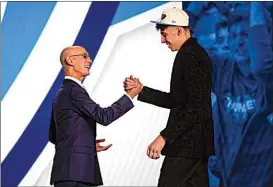  ?? ?? Chet Holmgren, right, is congratula­ted by NBA Commission­er Adam Silver after being selected second overall in the NBA draft by the Oklahoma Thunder Thursday in New York.
