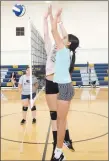  ?? Westside Eagle Observer/MIKE ECKELS ?? After Giselle Fuentes (out of shot) sends the ball over the net, Annabelle Bell (center) and Daisy Fuentes try to block the ball, sending it back to the offensive player during the June 9 Lady Bulldog volleyball practice in the gym at Decatur Middle School. The start of the 2022 Decatur volleyball season begins in a little over two months.