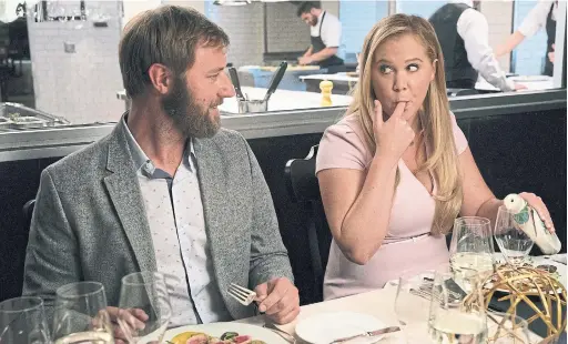  ?? MARK SCHÄFER/THE ASSOCIATED PRESS ?? Rory Scovel, left, and Amy Schumer in I Feel Pretty.