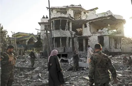  ?? — ap ?? All gone: afghan security personnel inspecting a damaged building in the aftermath of an attack in Kabul. the taliban have gained vast parts of rural afghanista­n since launching a series of offensives in May to coincide with the start of the final withdrawal of foreign troops.