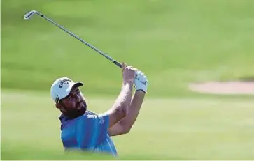  ?? AFP PIC ?? Marc Leishman hits his approach shot on the 16th during the first round of the BMW Championsh­ip on Thursday.