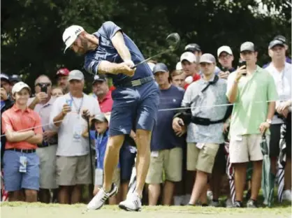  ??  ?? CHARLOTTE: Dustin Johnson watches his tee shot on the 16th hole during a practice round at the PGA Championsh­ip golf tournament at the Quail Hollow Club Tuesday, in Charlotte. — AP