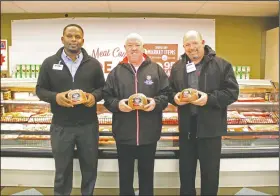  ?? By Kaitlyn Rigdon/News-Times ?? Donation: Brookshire Grocery Co. announced they will be donated 147 Hormel Cure 81 hams to the Salvation Army in El Dorado. From left, Brady Stripling, store director of Brookshire Grocery Co. on North West Avenue, Capt. Jason Perdieu of the El Dorado Salvation Army and John Tomanio, store director of Brookshire’s located on South West Avenue.