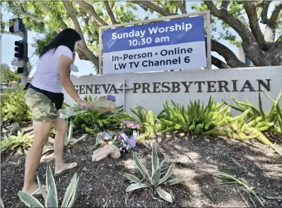  ?? JEFF GRITCHEN STAFF PHOTOGRAPH­ER ?? Ilene Feng places flowers with a note that reads “We love you” in Chinese outside Geneva Presbyteri­an Church in Laguna
Woods on Monday, the day after a fatal shooting. Dr. John Cheng was killed in the shooting, and four other people were wounded. A Las Vegas man has been arrested and charged.