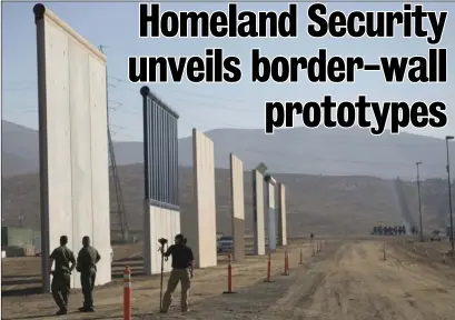  ??  ?? U.S. Border Patrol agents stand next to border wall prototypes that were unveiled Thursday in Otay Mesa. At far right are horse mounted agents. MARIO RENTERIA PHOTOS