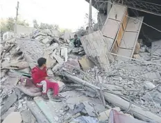  ?? ?? Boys sit amongst the rubble in Rafah following Israeli air strikes