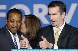  ?? —AFP ?? VIRGINIA: Gov-elect Ralph Northam (right) and Lt Gov-elect Justin Fairfax greet supporters at an election night rally in Fairfax, Virginia. Northam defeated Republican candidate Ed Gillespie.