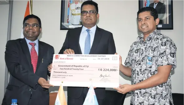  ?? Photo: Simione Haravanua ?? From left: Indian High Commission­er Vishvas Sapkal, Permanent Secretary for the Office of the Prime Minister Yogesh Karan, and Supervisor of Elections Mohammed Saneem with the cheque from the Indian High Commission on July 13, 2018.
