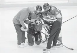  ?? WILFREDO LEE/AP ?? Panthers center Aleksander Barkov is helped off the ice after a play during the second period Tuesday’s game against the New York Islanders in Sunrise.