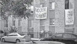  ?? ERIC BARADAT/AFP VIA GETTY IMAGES ?? Banners opposing evictions hang on a building in Washington, D.C. Experts fear COVID-19 layoffs could become permanent.