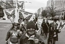  ?? Andrew Caballero-Reynolds / AFP via Getty Images ?? Activists and citizens with temporary protected status march toward the White House on Tuesday calling for immigratio­n reform legislatio­n.